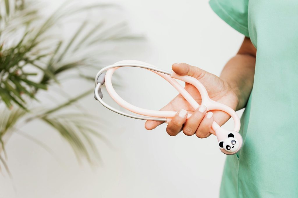 A medical professional holds a playful panda-themed stethoscope, blending fun and healthcare.